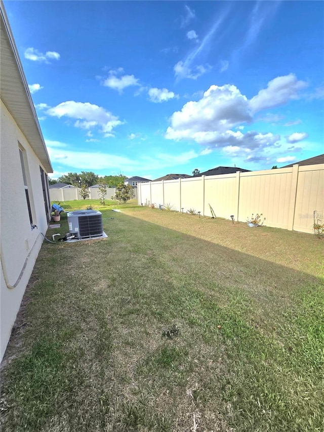 view of yard with central AC