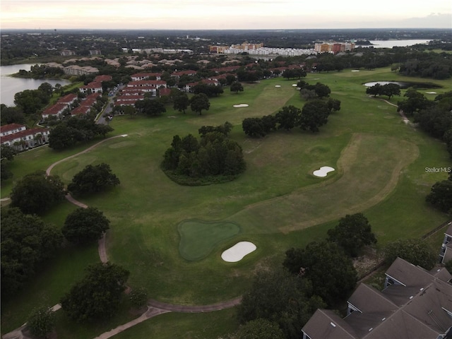 aerial view at dusk featuring a water view