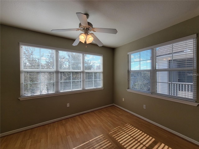 unfurnished room with hardwood / wood-style flooring and ceiling fan