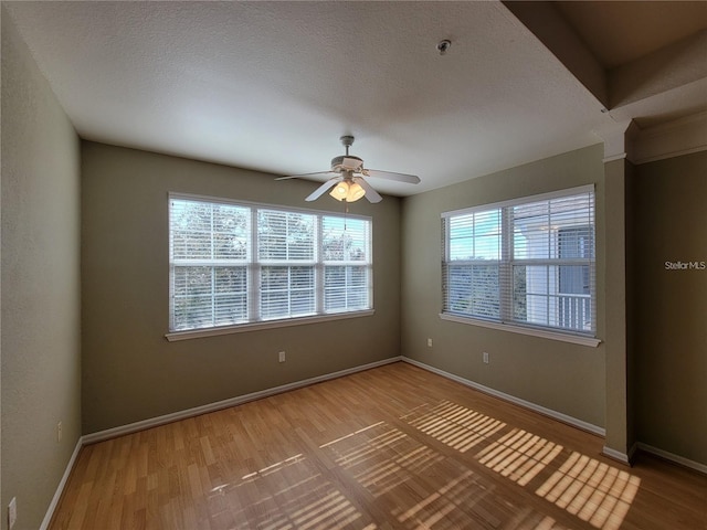 unfurnished room featuring hardwood / wood-style flooring and ceiling fan