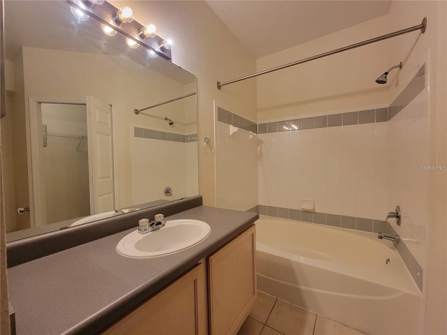 bathroom featuring tile patterned flooring, vanity, and tub / shower combination