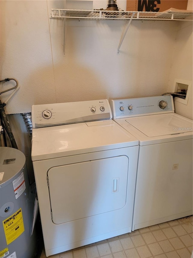 clothes washing area featuring washer and dryer and gas water heater