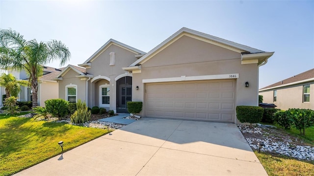 single story home featuring a front lawn and a garage