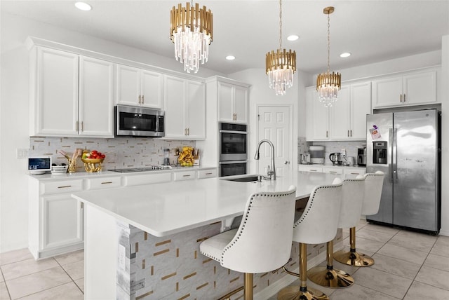 kitchen featuring a breakfast bar, light tile floors, tasteful backsplash, and appliances with stainless steel finishes