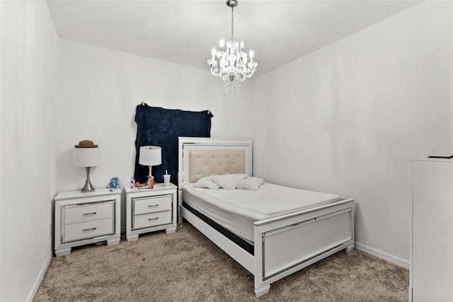 carpeted bedroom featuring an inviting chandelier