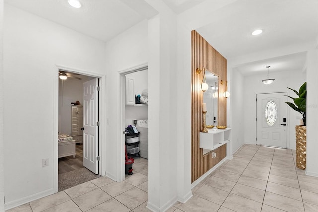 tiled foyer entrance with ceiling fan