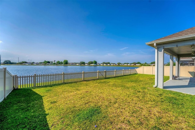 view of yard with a water view and a patio