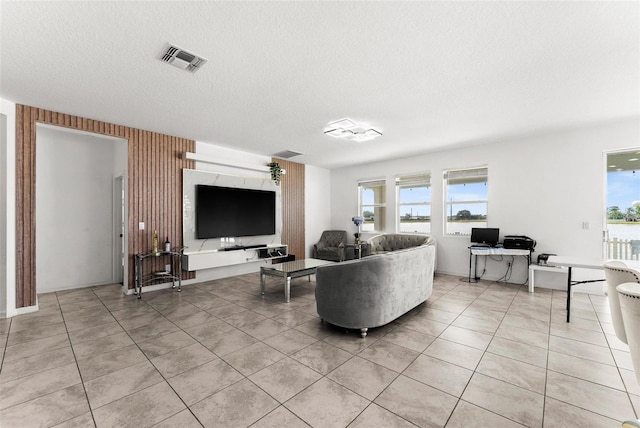 tiled living room featuring a textured ceiling