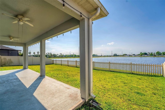 view of yard with a patio, a water view, and ceiling fan