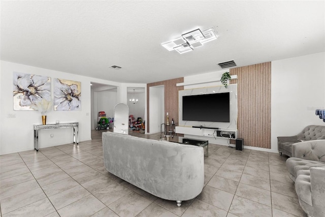 tiled living room featuring a chandelier