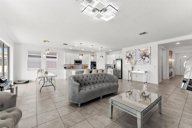 tiled living room with a textured ceiling