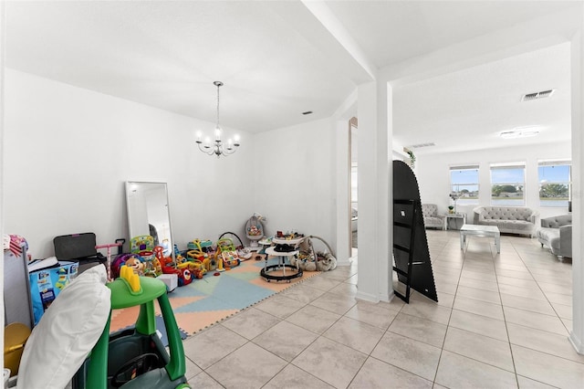 interior space featuring a chandelier and light tile flooring