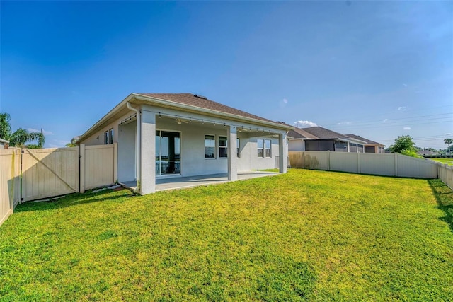 back of property with a patio and a lawn