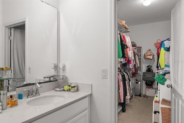 bathroom featuring a textured ceiling and vanity