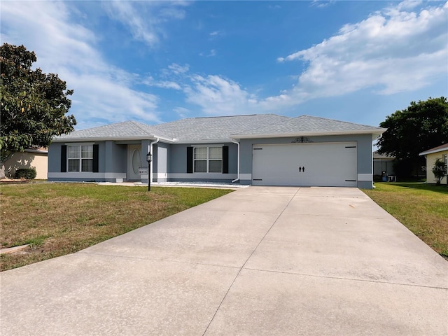 single story home featuring a front yard and a garage