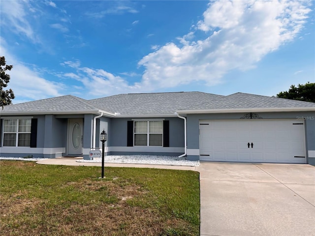 ranch-style home with a garage and a front yard