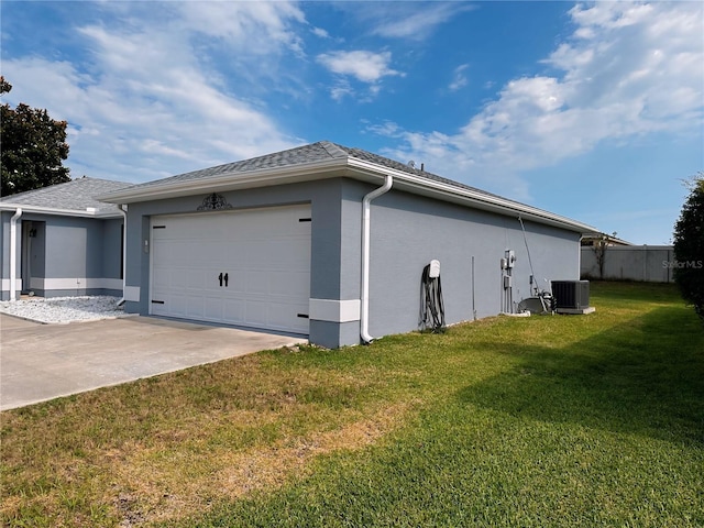 view of side of home featuring central AC, a garage, and a lawn