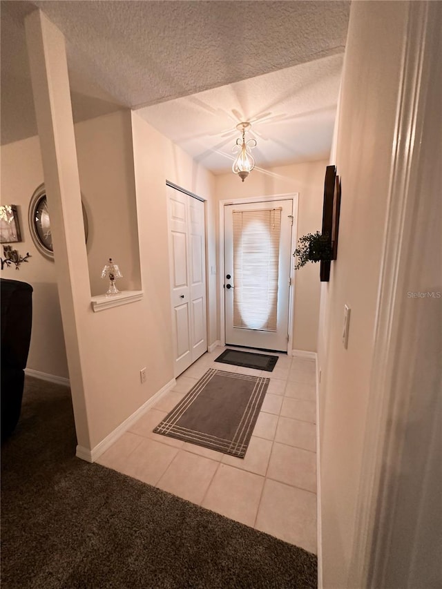 entrance foyer featuring tile floors and a textured ceiling