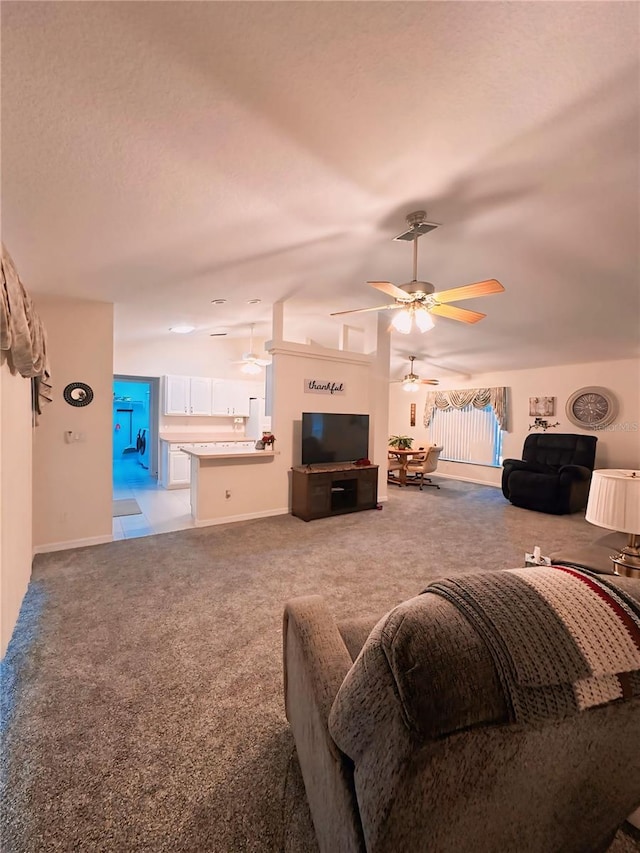 carpeted living room featuring ceiling fan