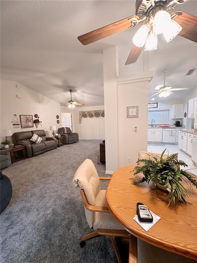 dining room featuring ceiling fan, carpet flooring, and sink