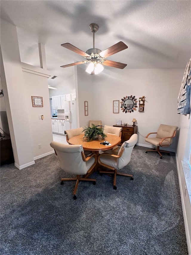 carpeted dining space with vaulted ceiling and ceiling fan