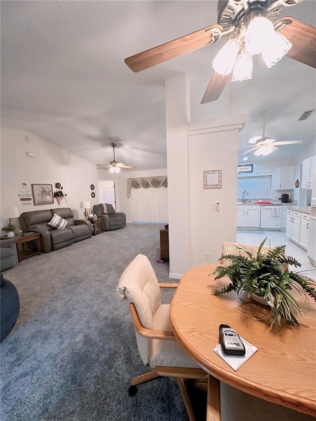 dining room featuring sink, carpet flooring, and ceiling fan