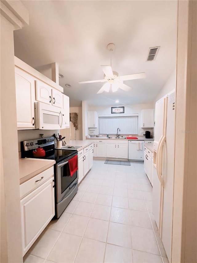 kitchen with ceiling fan, white appliances, light tile flooring, sink, and white cabinetry