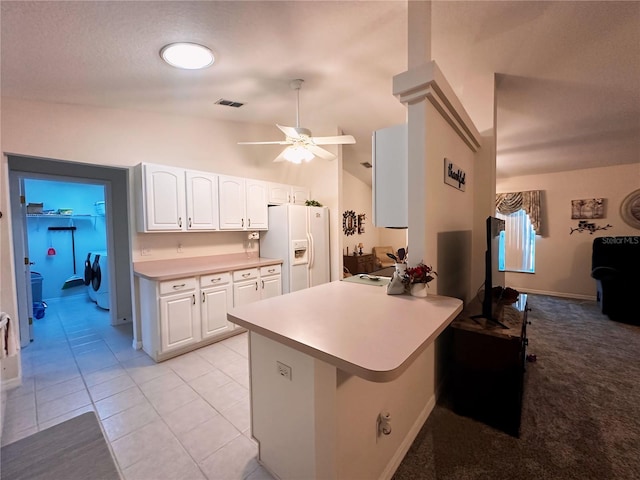 kitchen with independent washer and dryer, kitchen peninsula, ceiling fan, white refrigerator with ice dispenser, and light carpet