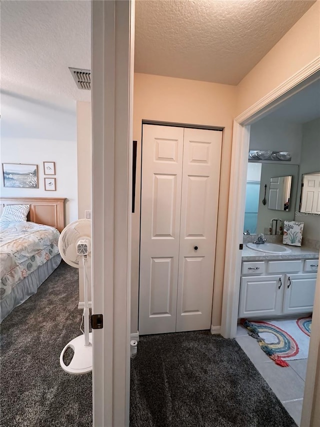 bathroom with vanity and a textured ceiling