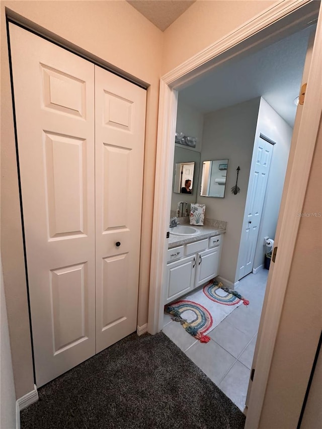 bathroom with tile flooring and vanity