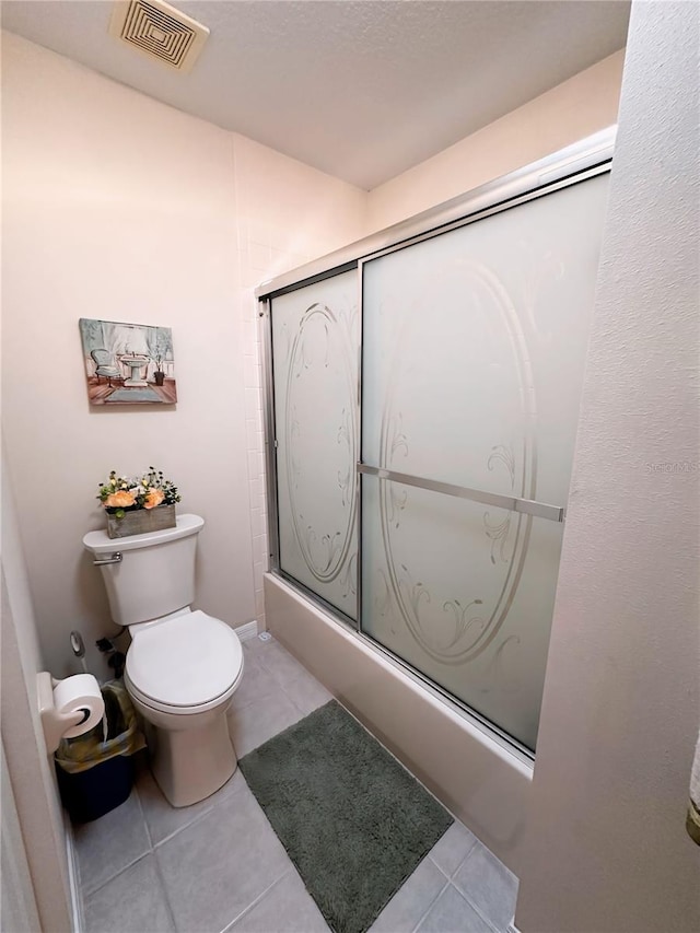 bathroom featuring tile flooring and toilet