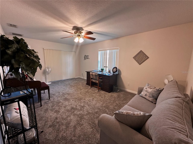 carpeted living room with a textured ceiling and ceiling fan