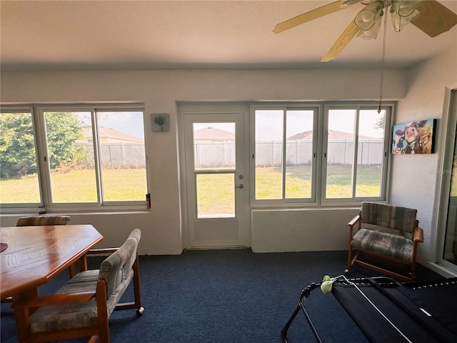 sunroom / solarium featuring ceiling fan