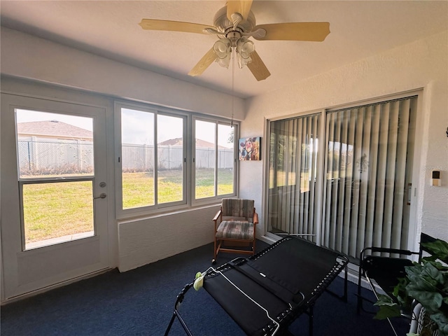 sunroom / solarium featuring plenty of natural light and ceiling fan