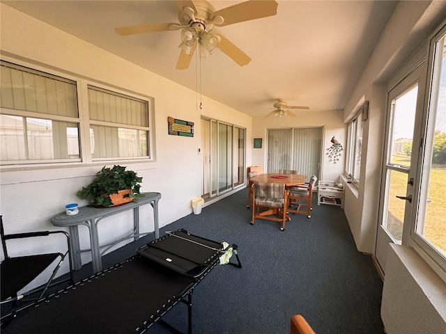 sunroom featuring ceiling fan