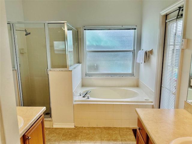 bathroom with shower with separate bathtub, tile patterned floors, and vanity