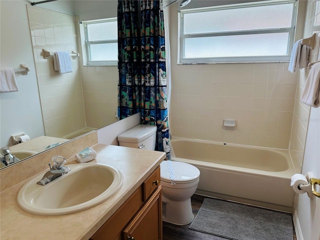 full bathroom with vanity, shower / bathtub combination with curtain, toilet, and a healthy amount of sunlight