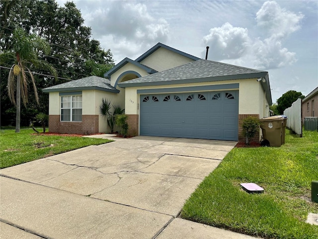 ranch-style house featuring a garage, central air condition unit, and a front yard