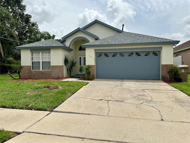 ranch-style home featuring a garage and a front lawn