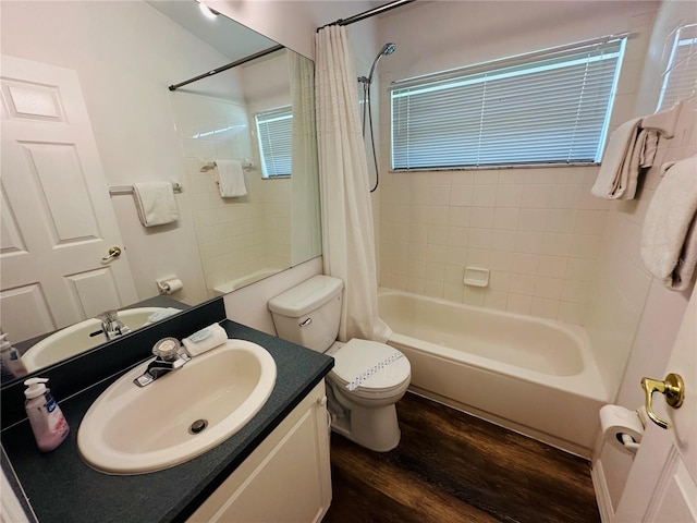 full bathroom featuring vanity, toilet, wood-type flooring, and shower / tub combo