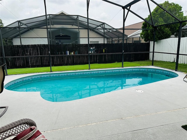 view of pool with a patio, a lanai, and a lawn