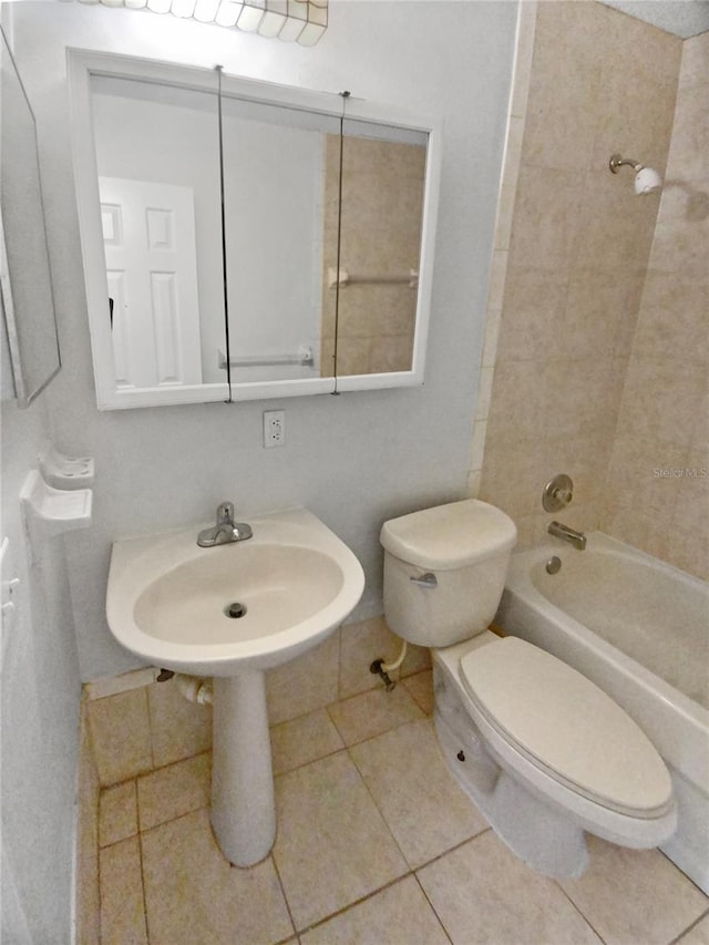 bathroom featuring tile flooring, toilet, and tiled shower / bath combo