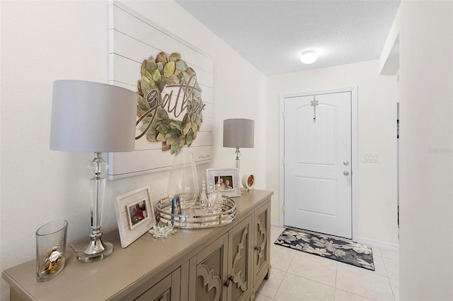 entrance foyer featuring light tile floors