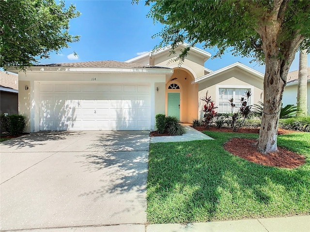 view of front of property with a garage and a front yard