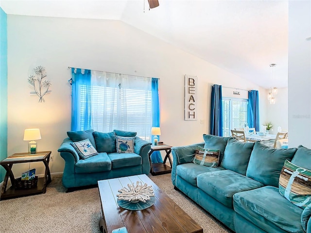 living room featuring carpet, ceiling fan, and vaulted ceiling