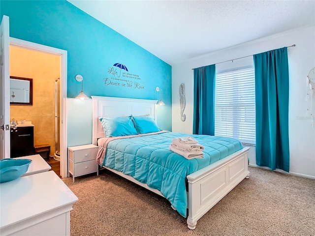 carpeted bedroom with lofted ceiling