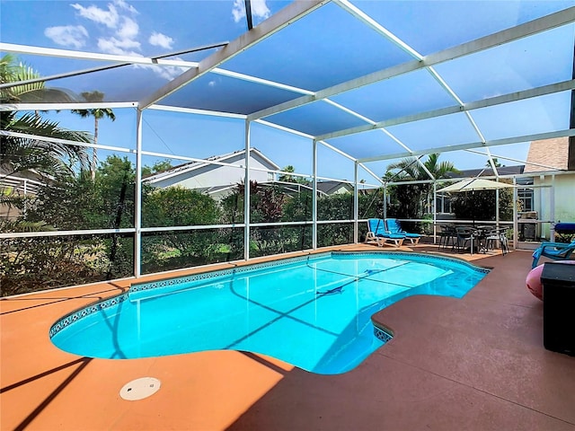 view of swimming pool with a patio and a lanai