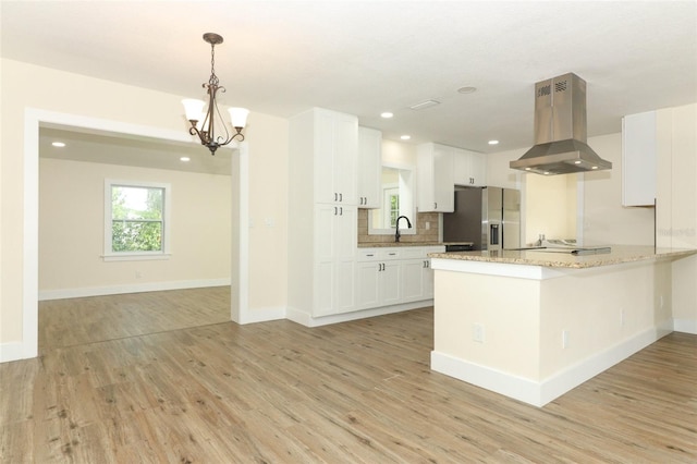 kitchen featuring white cabinets, stainless steel refrigerator with ice dispenser, ventilation hood, pendant lighting, and light hardwood / wood-style flooring