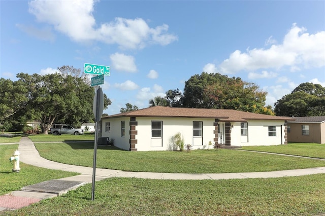 ranch-style home with central AC and a front yard