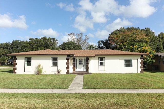 ranch-style home with a front yard and french doors